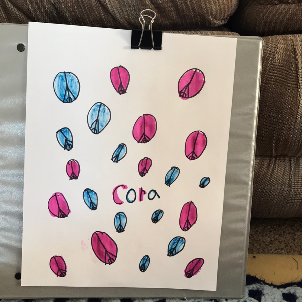 It is blue and pink has peace sines name on it is Cora.